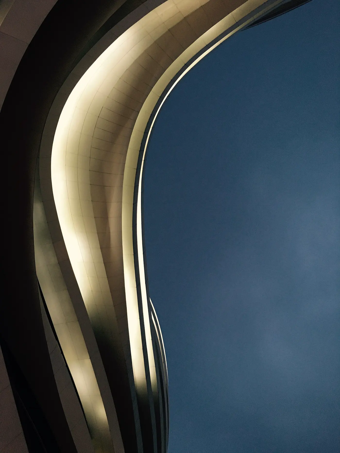 A close view of a luminous contemporary architectural curve