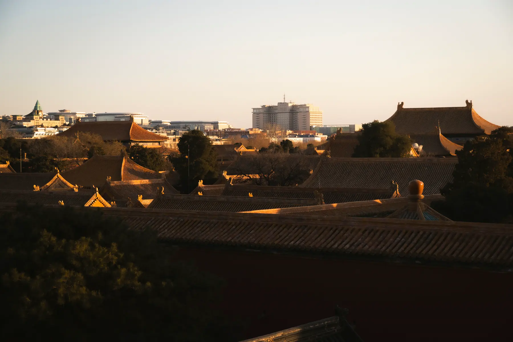 The tiled roofs of the Forbidden City at sunset