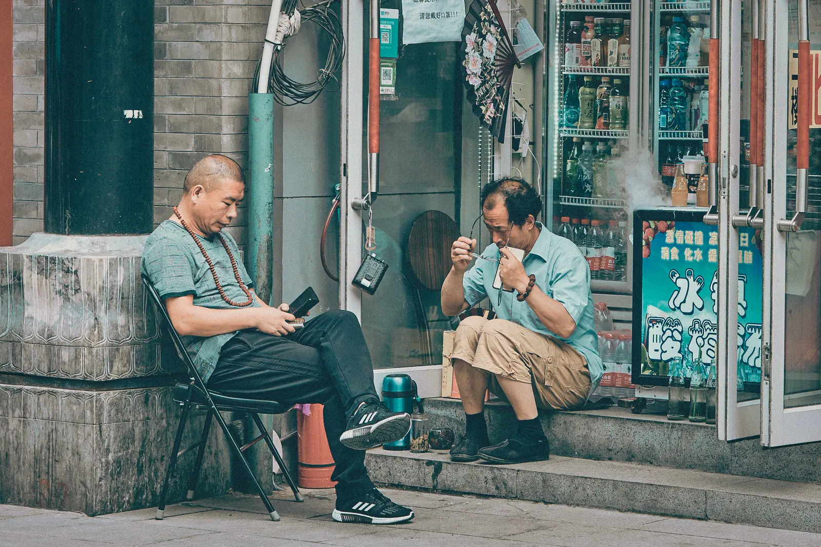 Two men talking outside a neighborhood shop