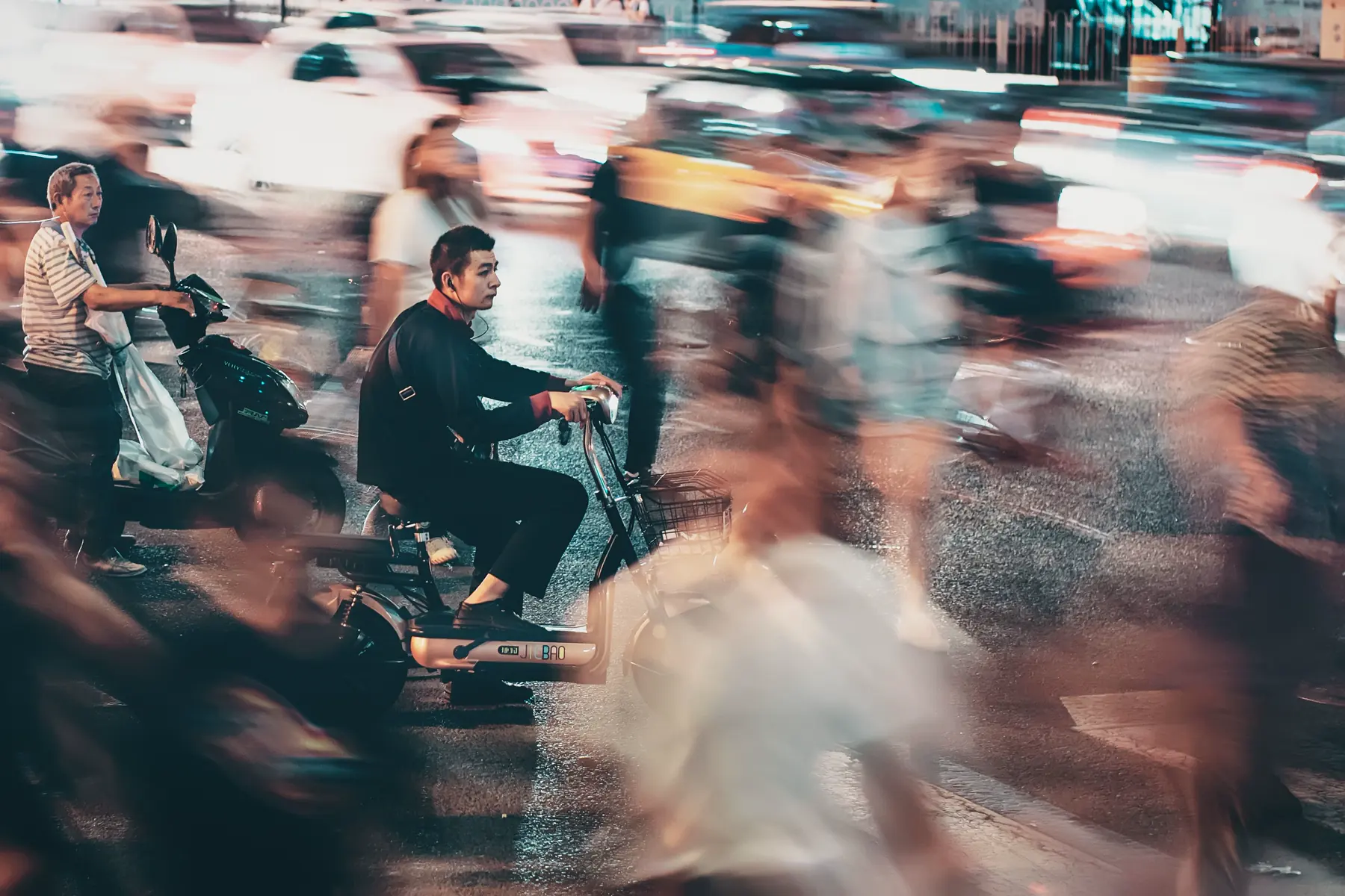 A cyclist held sharply against a moving Beijing crowd