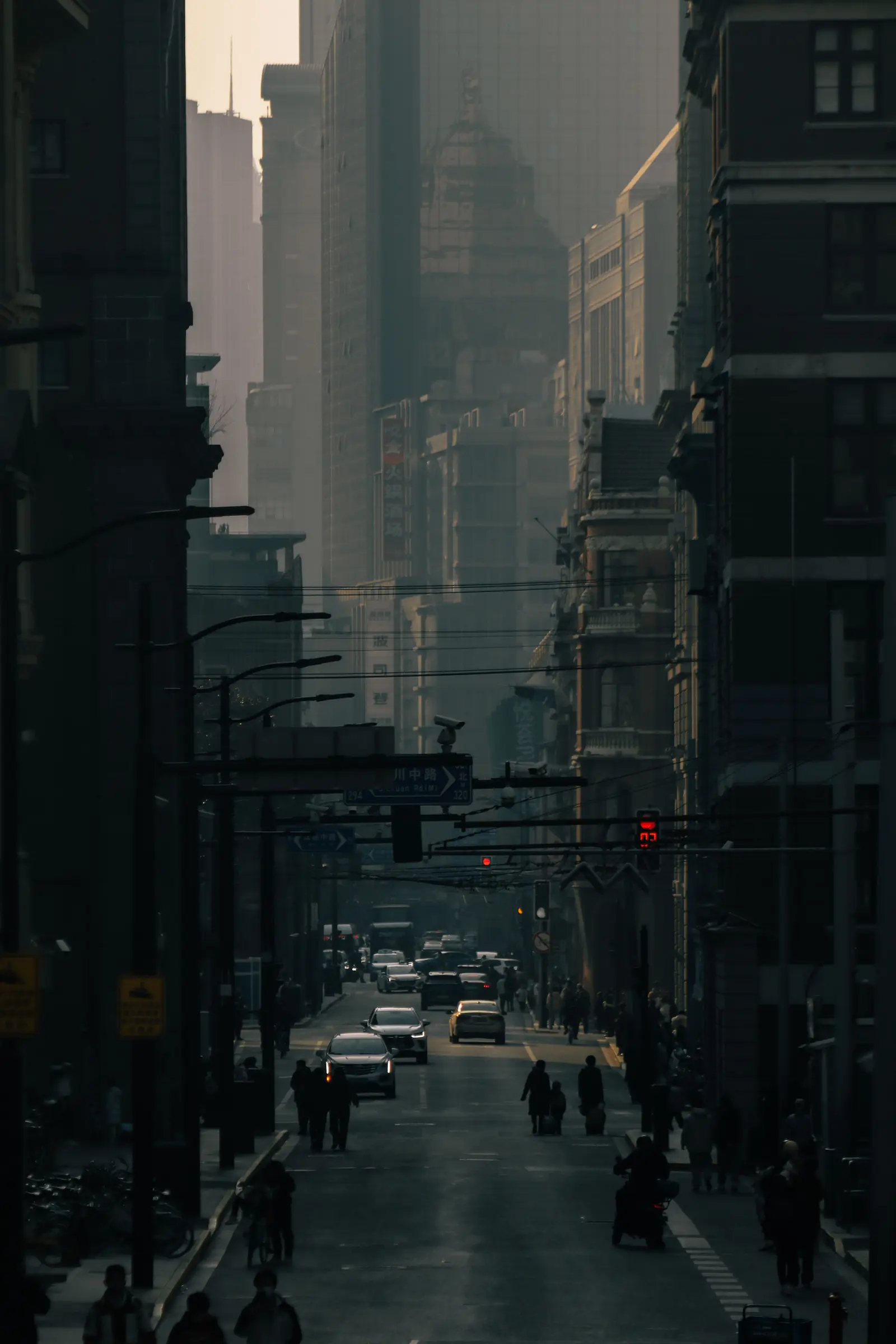 A narrow Shanghai street emerging from morning shadow