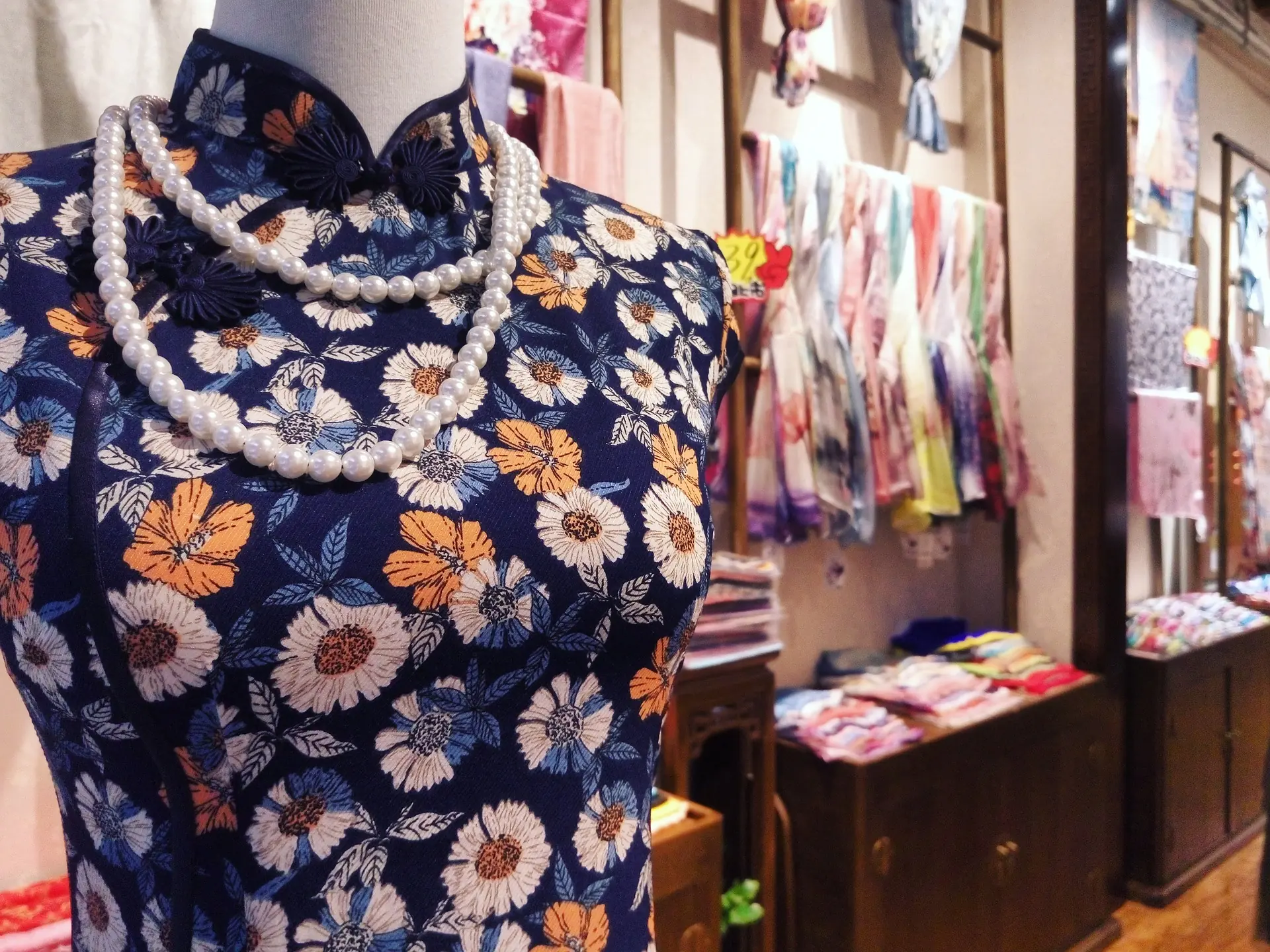 A patterned qipao displayed inside a Shanghai clothing shop