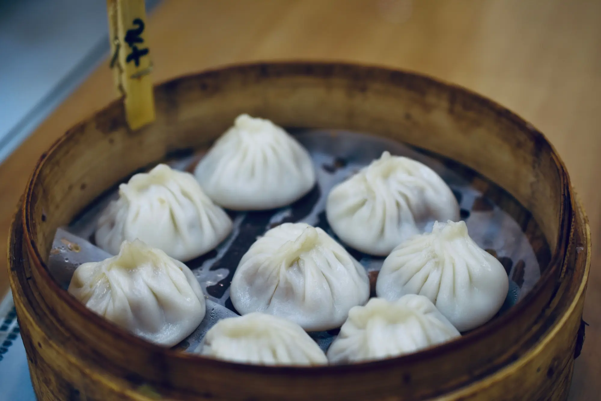 Fresh xiaolongbao served in a bamboo basket in Shanghai
