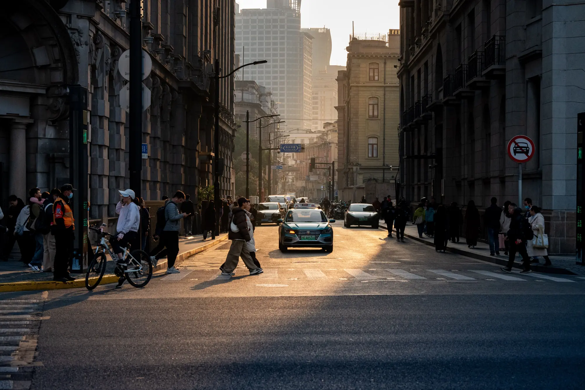 Warm evening light crossing Yuanmingyuan Road in Shanghai