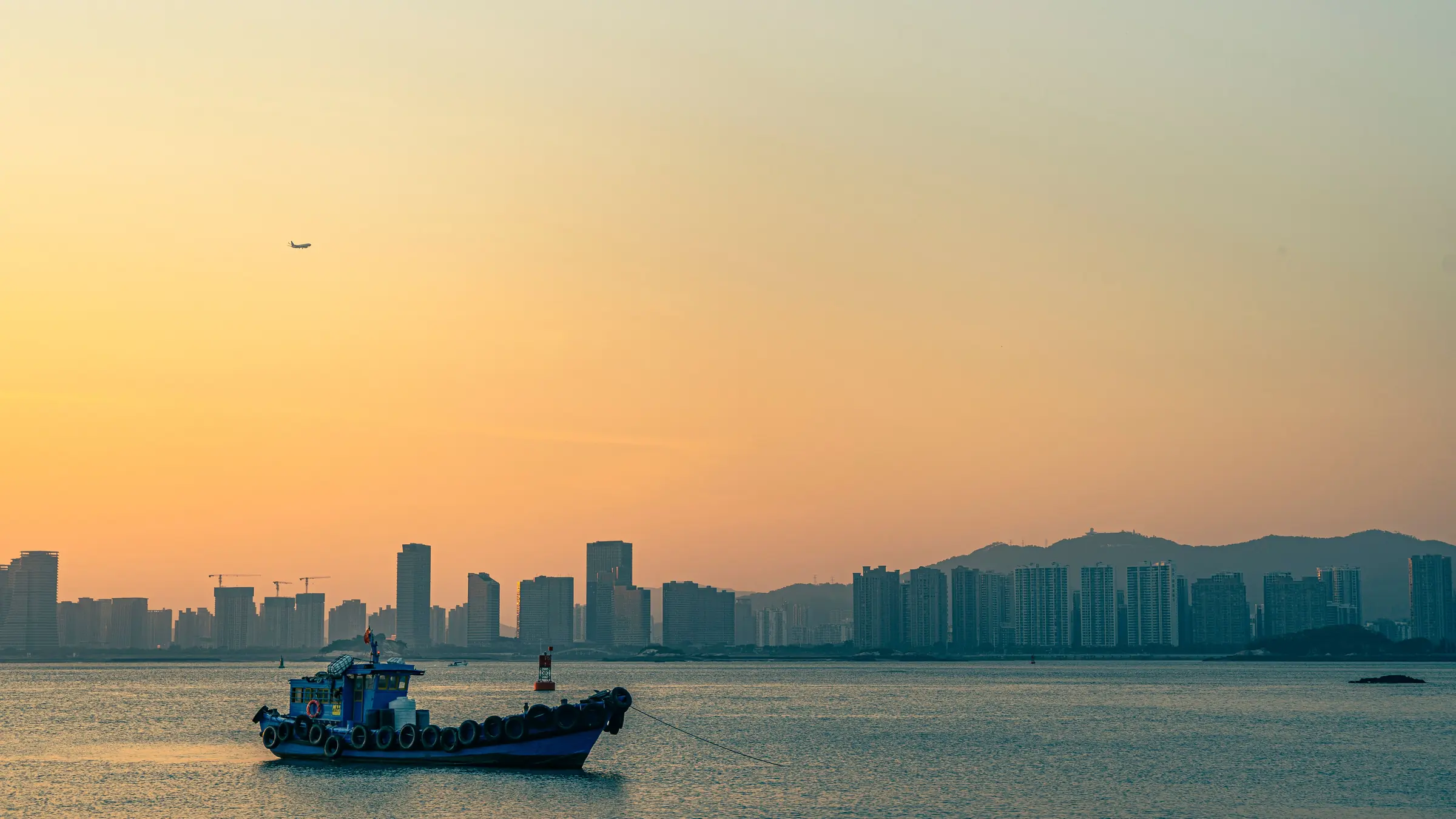 A ferry crossing Xiamen Bay in warm evening light