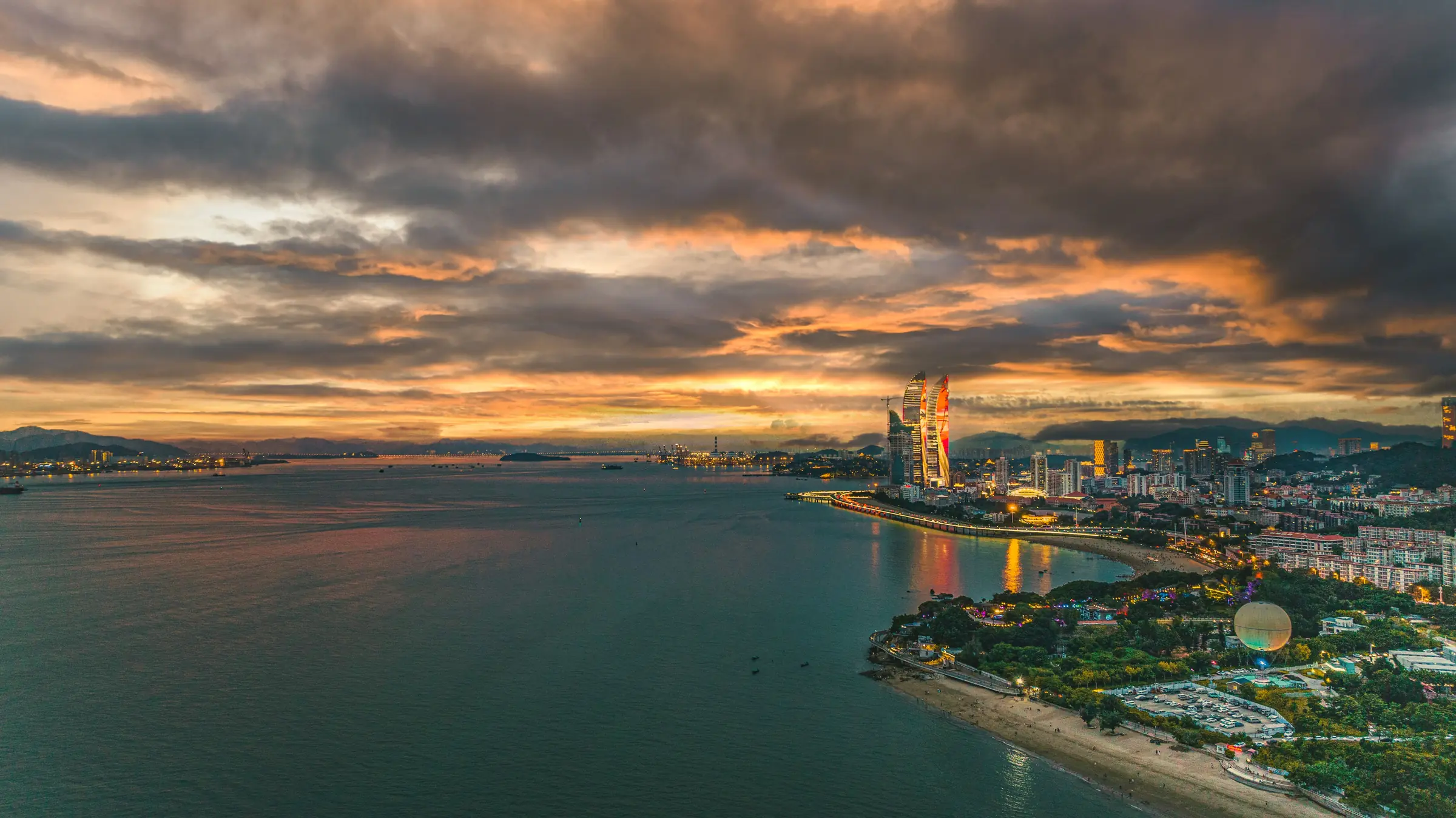 Xiamen coastline beneath a dramatic sunset sky