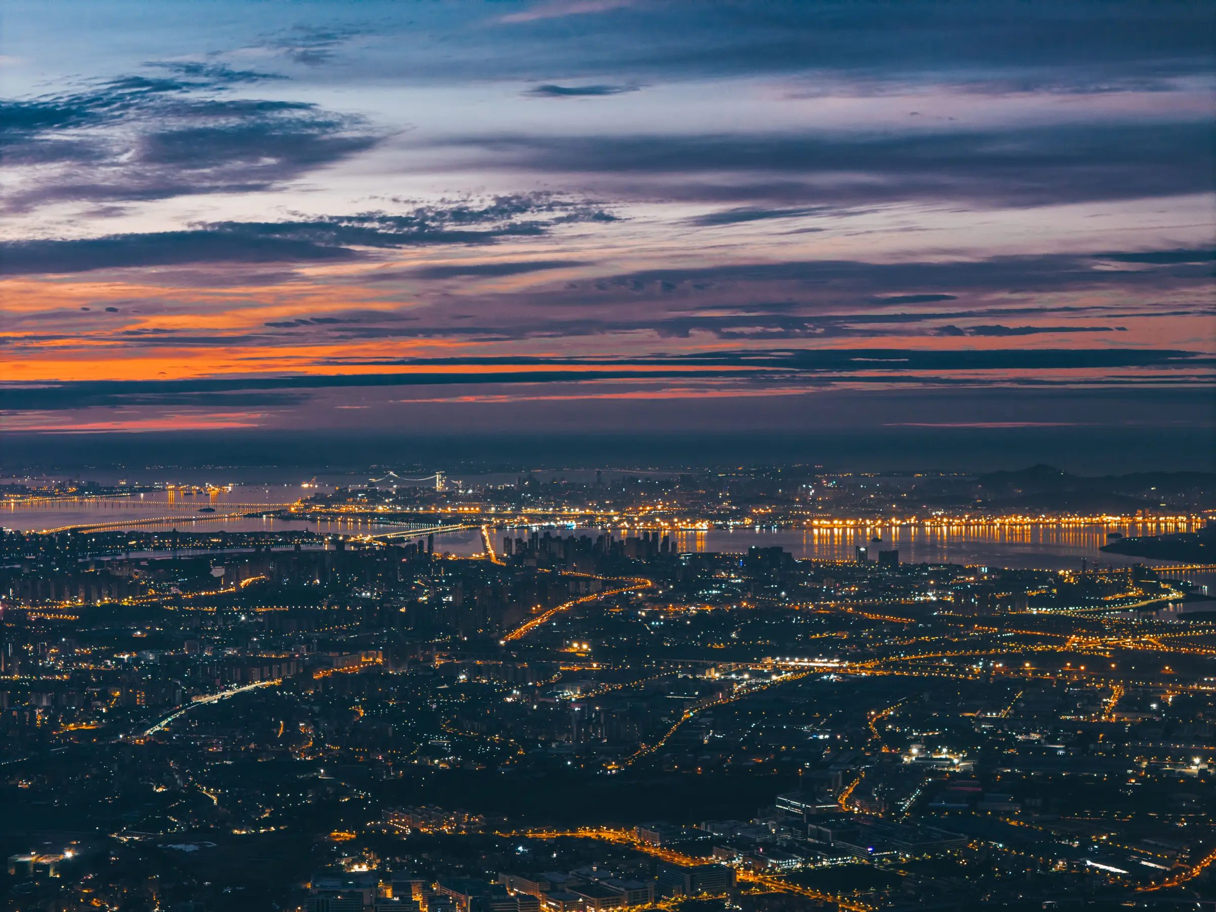 Xiamen city lights spreading around the bay at night