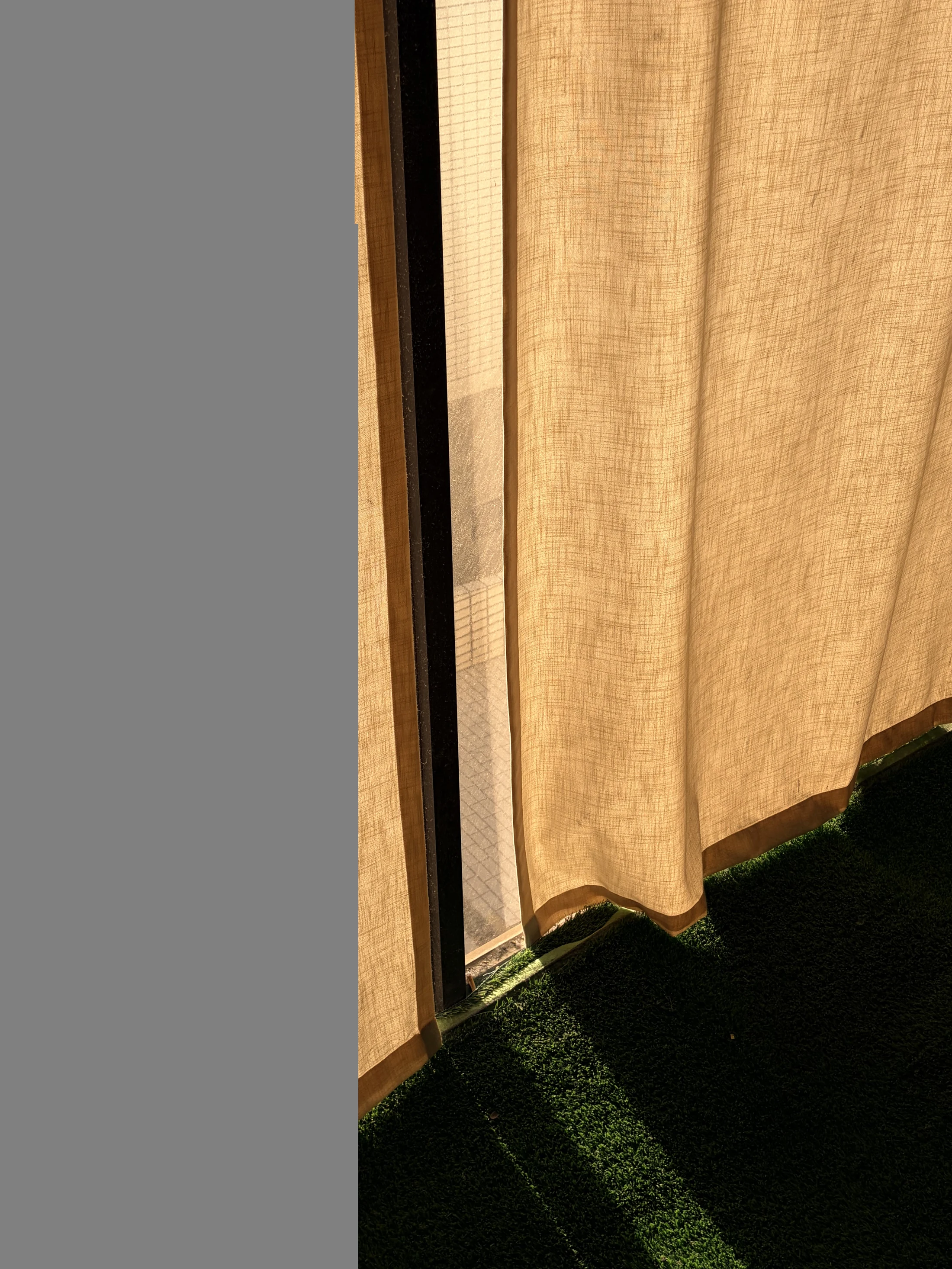 A narrow line of sunlight passing through a museum curtain