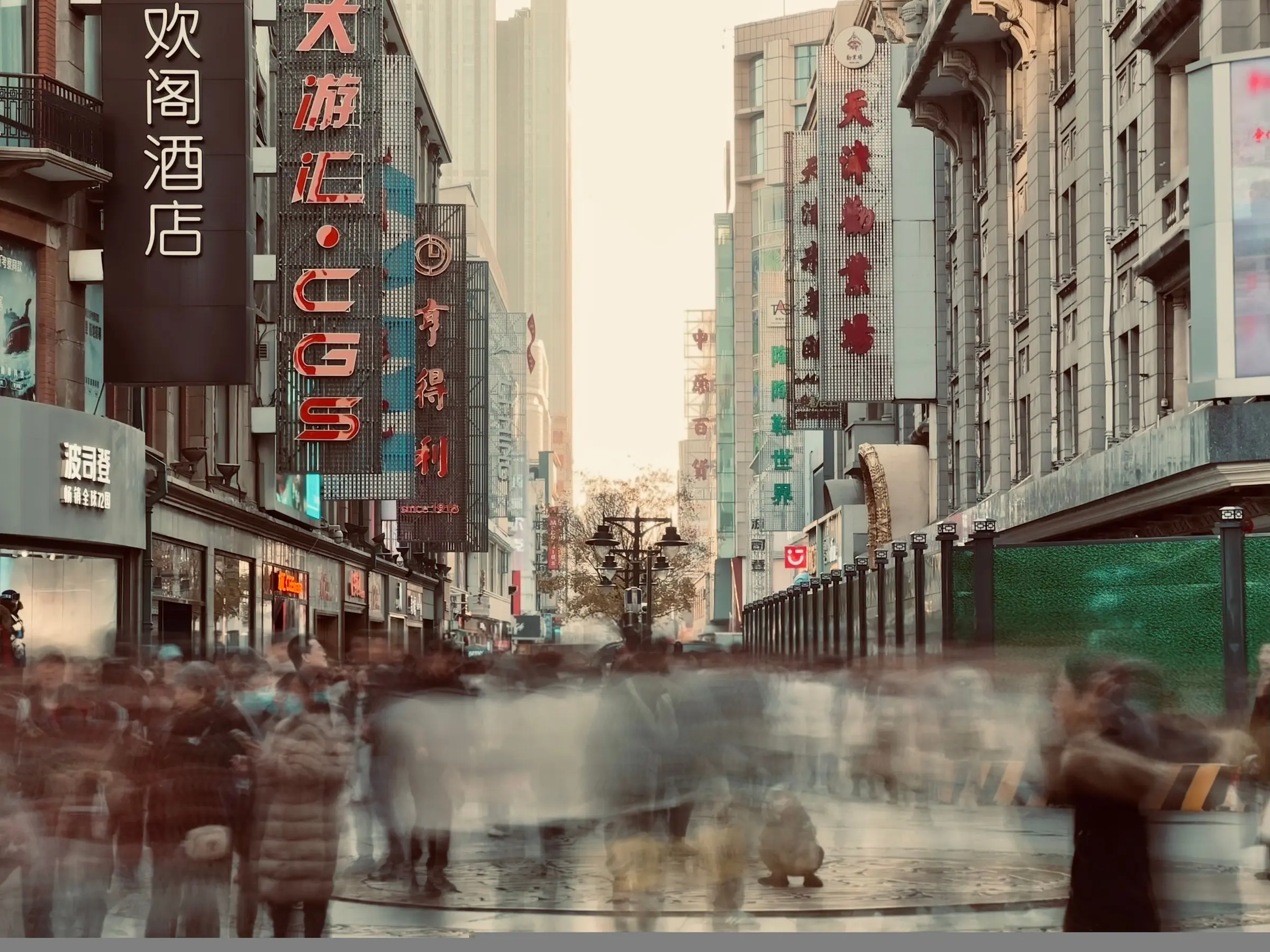 A dense crowd moving through a historic shopping street